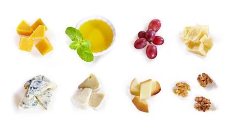 Different type of cheese with honey, grape, nuts on white background. Top view Stock Photos