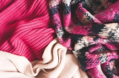 Different type of knitted clothes closeup top view. Winter season. Selective  Stock Photos