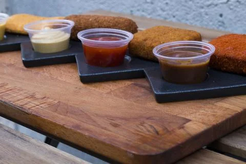 Different type pf simple american fried food on an wooden background. Chicken Stock-Fotos