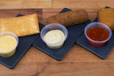 Different type pf simple american fried food on an wooden background. Chicken Stock-Fotos