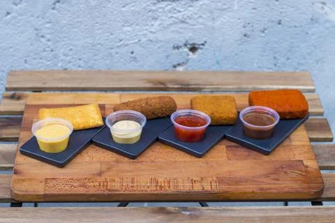 Different type pf simple american fried food on an wooden background. Chicken Stock Photos