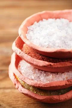 Different type of salt in rustic clay bowls Stock Photos