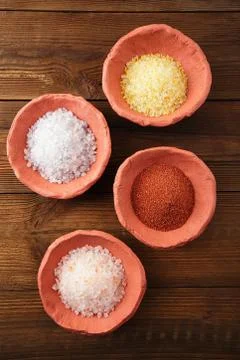 Different type of salt in rustic clay bowls Stock Photos