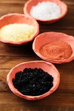 Different type of salt in rustic clay bowls Stock Photos