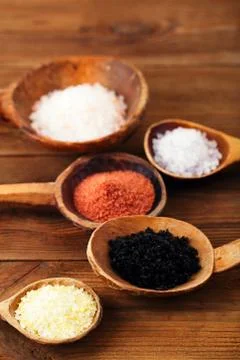 Different type of salt in rustic clay bowls Stock Photos
