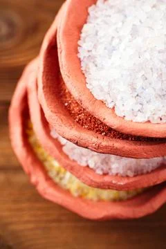 Different type of salt in rustic clay bowls Stock Photos