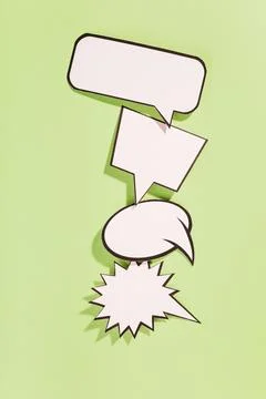 Different type white retro speech bubbles green background Stock Photos