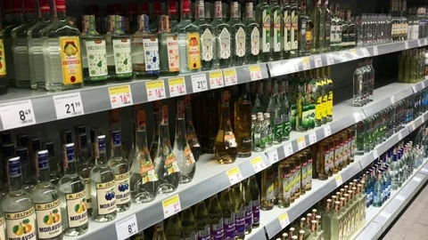Different types of alcohol on the shelves inside grocery store Stock Footage 203293518