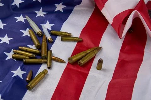 Different types of ammunition on top of flag of the United States. Stock Photos