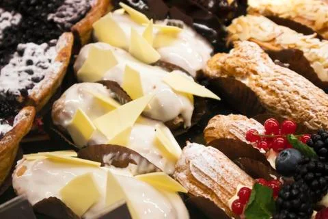 Different types of appetizing cakes lying in a showcase Stock Photos