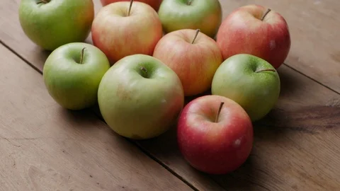 Different types of apples on an old wooden table Stock Footage 121294559