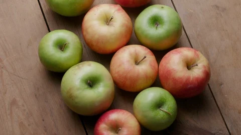 Different types of apples on an old wooden table Stock Footage 121294623
