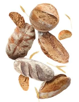 Different types of bread and spikes falling on white background Stock Photos