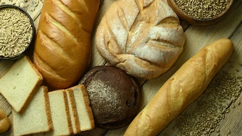 Different types of bread are spinning on the table Stock Footage 126764945