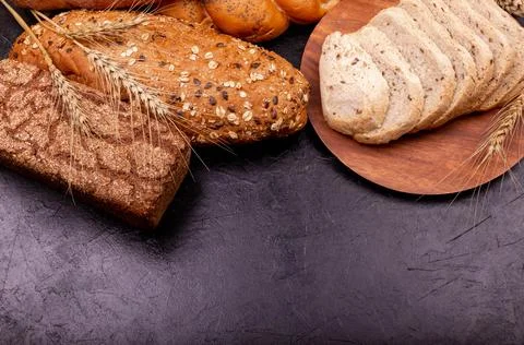 Different types of bread. Assortment of bread on grey background. Foto stock
