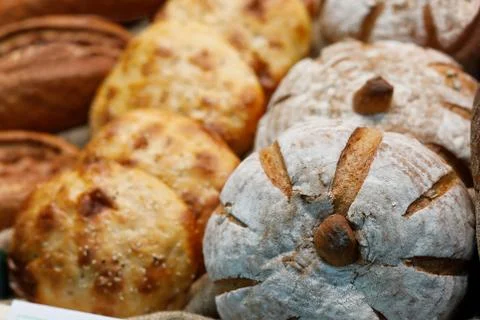Different types of bread on the bakery shelf Stock Photos