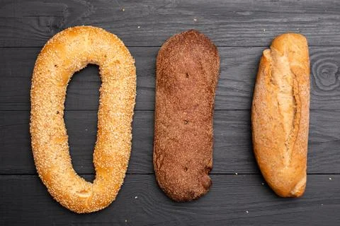 Different types of bread on a black background. Stock Photos