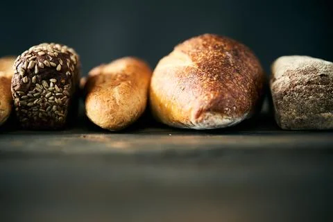 Different types of bread loaves close up with copy space Stock Photos
