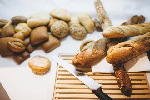 Different types of bread on the table in the kitchen Stock Photos