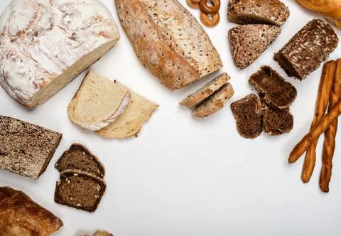 Different types of bread on a white background. Top view. Copy space. Stock Photos