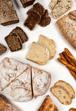 Different types of bread on a white background. Top view. Stock Photos