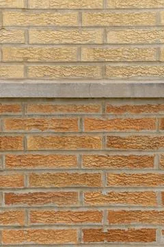 Different types of bricks and texture patterns on a building wall in daylig.. Stock Photos
