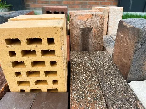 Different types of bricks stacked beautifully on green grass 写真素材