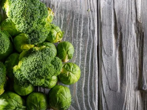 Different types of cabbage on wooden background. Stock Photos