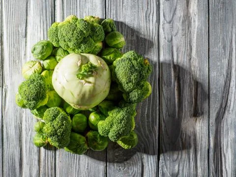 Different types of cabbage on wooden background. Stock Photos