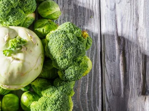 Different types of cabbage on wooden background. Stock Photos