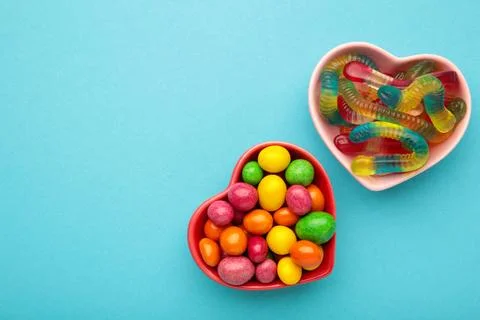 Different types of candies on blue background, copy space. Colorful birthday  Stock Photos