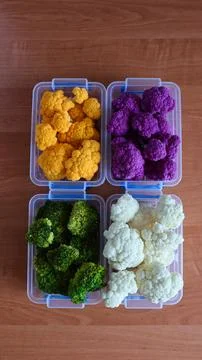 Different types of cauliflower and broccoli arranged in plastic containers on Stock Photos
