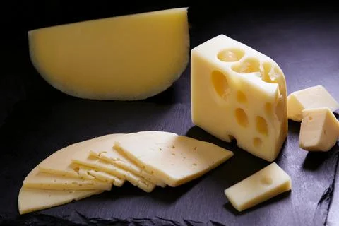 Different types of cheese on stone plate. Cheese background. Stock Photos
