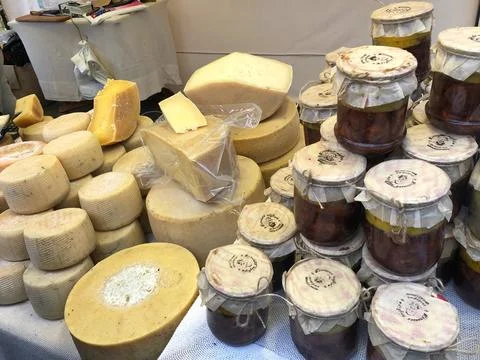 Different types of cheese on the table. Many cheese is sold at an agricultura Stock Photos