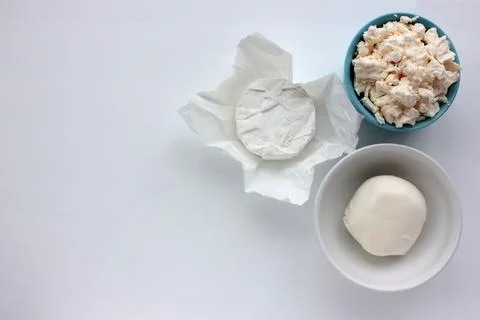 Different types of cheese on white table. Stock Photos