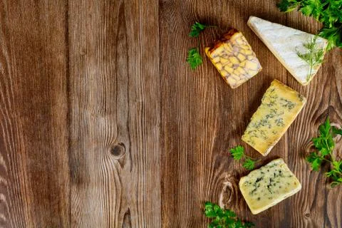 Different types of cheese on wooden background. Stock Photos