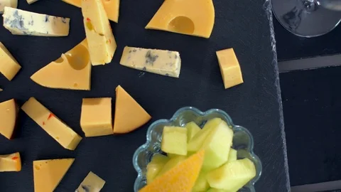 Different types of cheeses on black stone look very appetizing Vídeo Stock 109126777