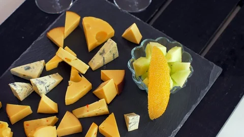 Different types of cheeses on black stone look very appetizing Stock Footage 109127803