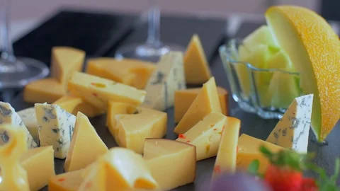 Different types of cheeses on black stone look very appetizing 動画素材 109128116