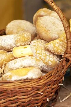 Different types of cheeses. Collection of cheese in wicker basket Stock Photos