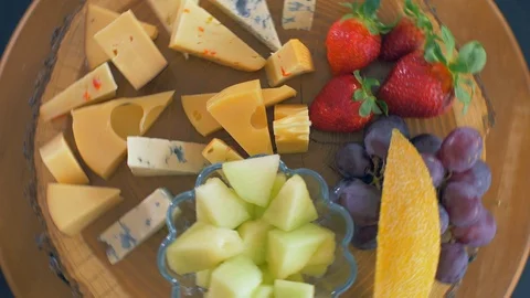 Different types of cheeses on a wooden board are rotating in a circle 動画素材 109126965