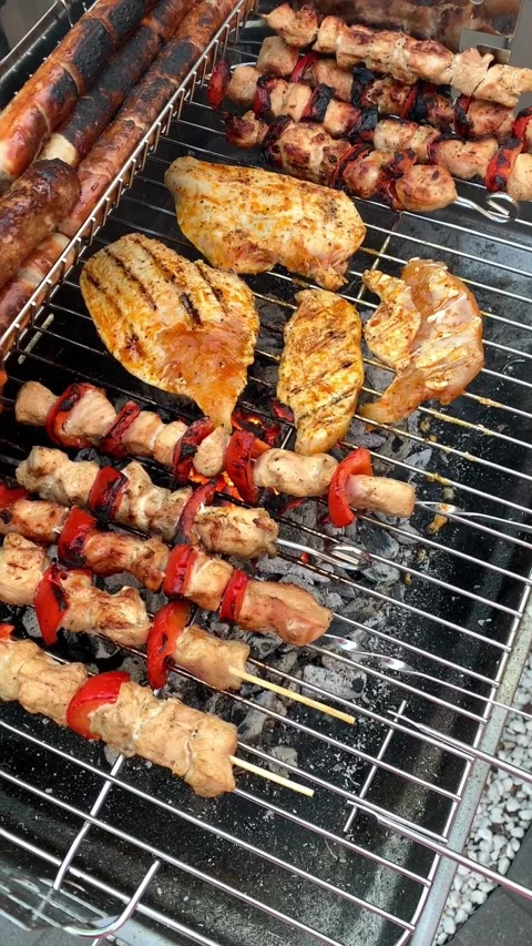 Different types of chicken meat, steak and sausage are fried on barbecue, j.. Video stock 316681399