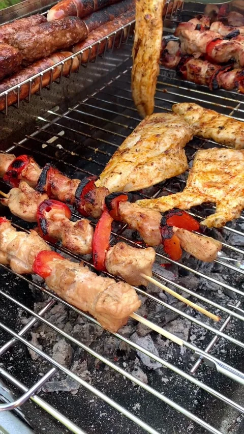 Different types of chicken meat, steak and sausage are fried on barbecue, j.. Video stock 316681538