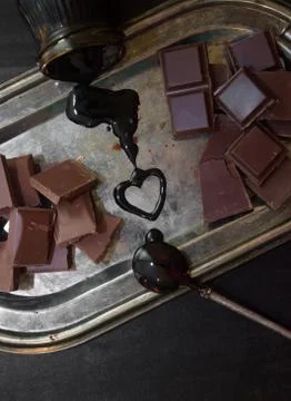 Different types of chocolate on a silver tray on a black background Foto stock