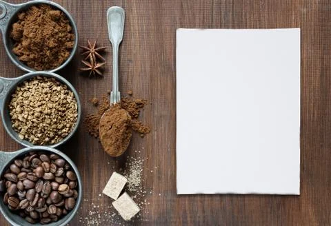 Different types of coffee and white card are on a wooden background Stock-Fotos