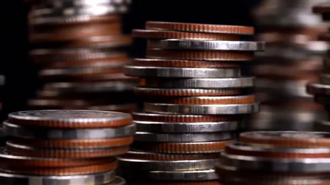 Different types of coins stacked on a black background, Stock Footage 169208927