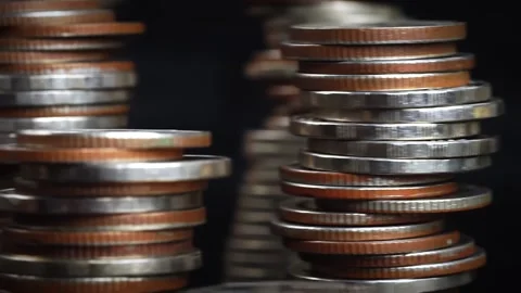 Different types of coins stacked on a black background, Stock Footage 169208939