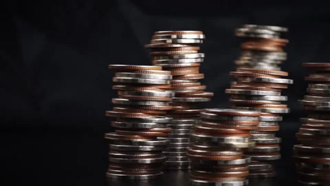 Different types of coins stacked on a black background, Stock Footage 169208947