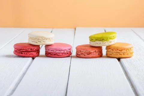 Different types color of macaroons on white wooden background Stock Photos