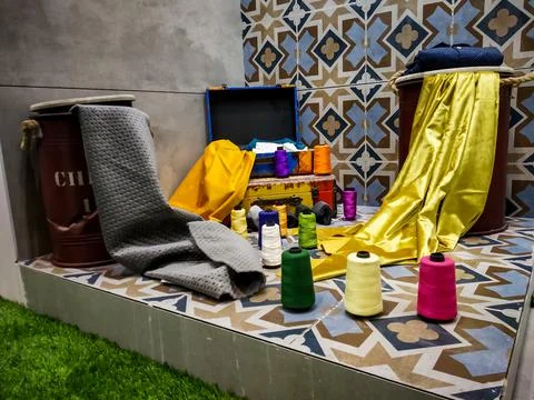 Different types of colorful fabrics composition with its thread Stock Photos